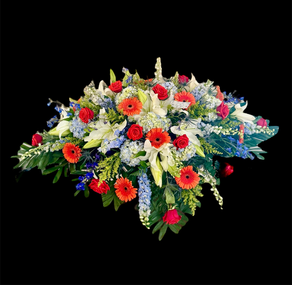 Blue, orange & white casket spray