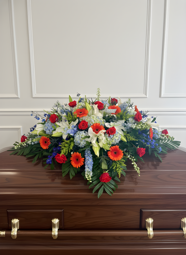 Blue, orange & white casket spray